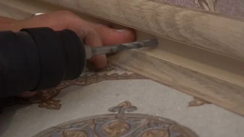 The process of installing the floor, a working hammer drills for anchoring to Stock Footage 79600198