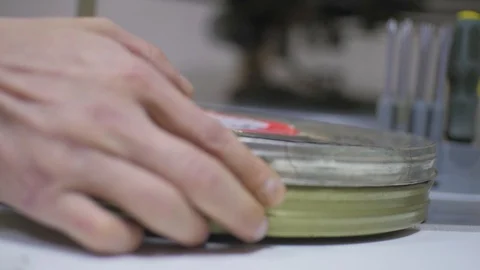 The process of installing old film into the reel to watch a movie at the cinema Stock Footage 93712909