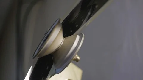 The process of installing old film into the reel to watch a movie at the cinema Stock Footage 93713006