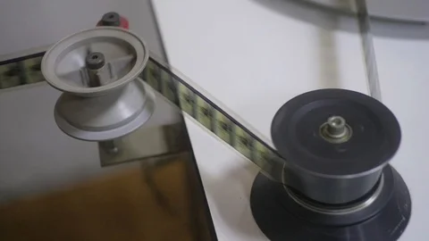The process of installing old film into the reel to watch a movie at the cinema Stock Footage 93713451