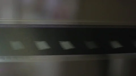 The process of installing old film into the reel to watch a movie at the cinema Stock Footage 93713587