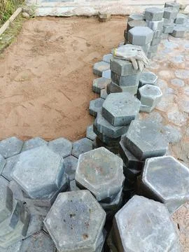 The process of installing pentagon-shaped paving blocks. Stock Photos
