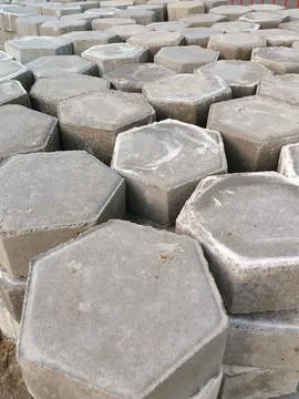 The process of installing pentagon-shaped paving blocks. Stock Photos