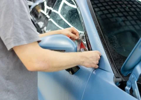 The process of installing PPF on the side of the car Stock Photos