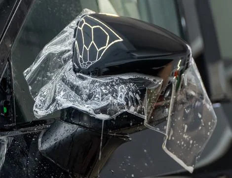 The process of installing PPF on the side of the car. Stock Photos