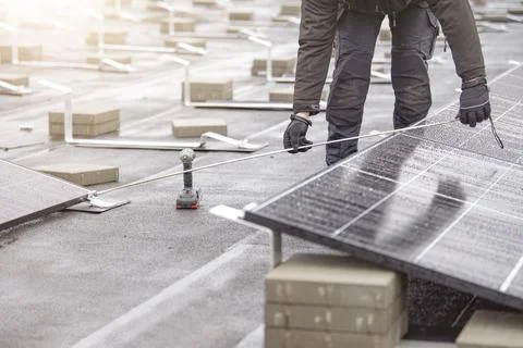 The process of installing solar panels. The installer measures the distance Foto stock