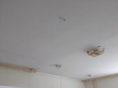The process of installing a stretch ceiling on a laser level Stock Photos