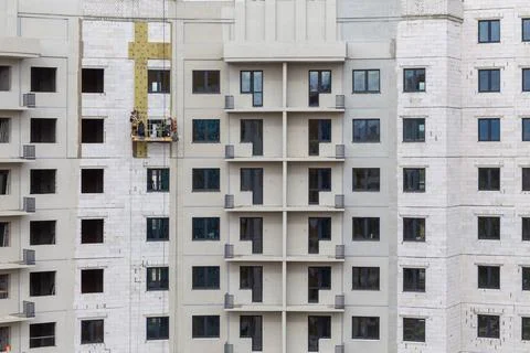 The process of insulating external walls in a multi-storey building under con Fotos Stock