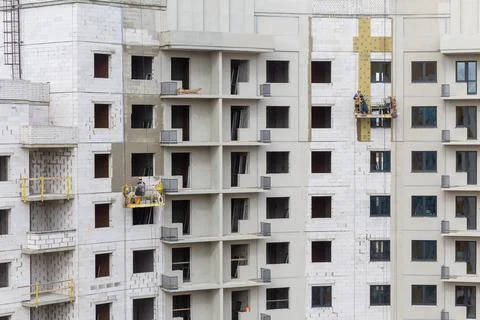 The process of insulating external walls in a multi-storey building under con Fotos Stock