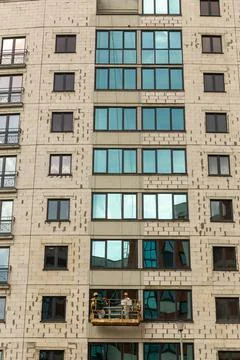 The process of insulating external walls in a multi-storey building under con Stock Photos