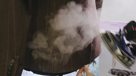 Process of ironing male jacket on the mannequin Stock Footage 106927310
