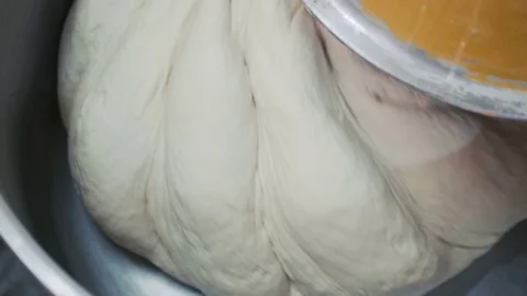 A process of kneading a big amount of dough 4K Stock-Footage 70683371