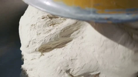 A process of kneading a big amount of dough 4K Stock-Footage 70684582