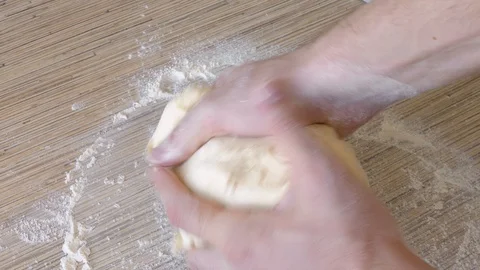 Process of kneading  dough. Hands kneading dough. Stock Footage 126327410