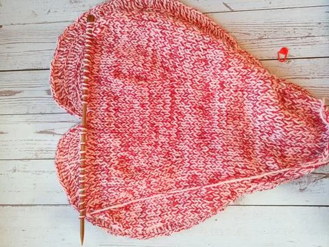 The process of knitting and crocheting pillows in the shape of a pink heart Stock Photos