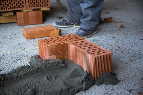 The process of laying bricks on construction site Stock Photos