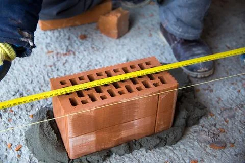 The process of laying bricks on construction site Stock Photos
