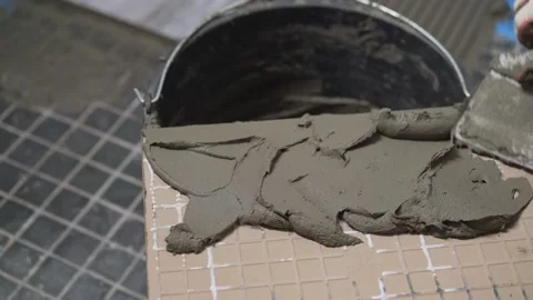 The process of laying ceramic floor tiles with a herringbone pattern. spreading Stock Footage 158467587