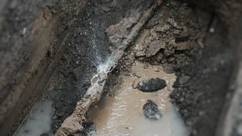 The process of laying a plastic gas pipe underground. Stock Footage 318268134