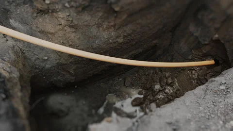 The process of laying a plastic gas pipe underground. Stock Footage 318268245