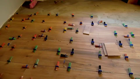 The process of laying tiles on the floor with self levelling spacer Stock Footage 147218154