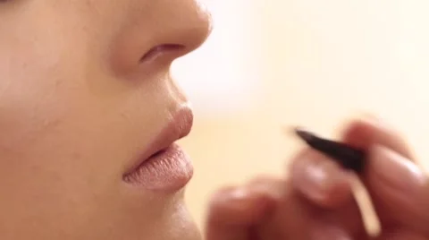 Process of lips make up with a paintbrush Stock Footage