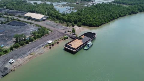 The process of loading coal onto a barge using a transport truck Stock Footage 283657712