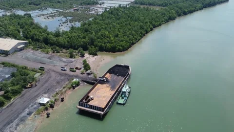 The process of loading coal onto a barge using a transport truck Stock Footage 283657721