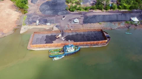 The process of loading coal onto barges using heavy transport cars Stock Footage 263611954