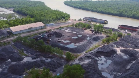 The process of loading coal onto barges using heavy transport cars Stock Footage 263612057