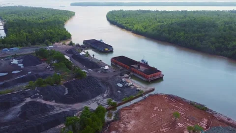The process of loading coal onto barges using heavy transport cars Stock Footage 263612058