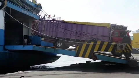 The process of loading a truck full of goods onto a ship Video stock 221892676