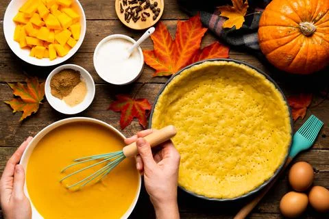 The process of making American pumpkin pie women's hands on a wooden table with Foto stock