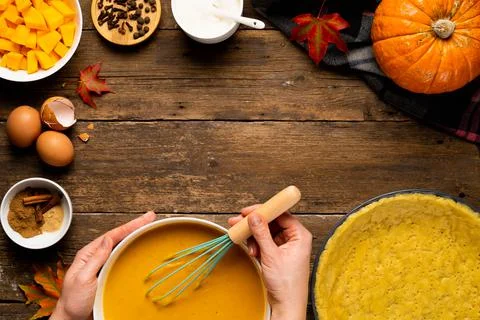 The process of making American pumpkin pie women's hands on a wooden table wi Stock Photos