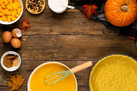 The process of making American pumpkin pie on a wooden table with ingredients Stock Photos