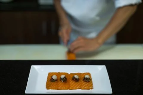 The process of making and decorating salmon sashimi. Stock Photos