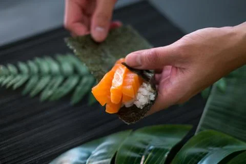 The process of making and decorating salmon Temaki Hand Roll. Stock Photos