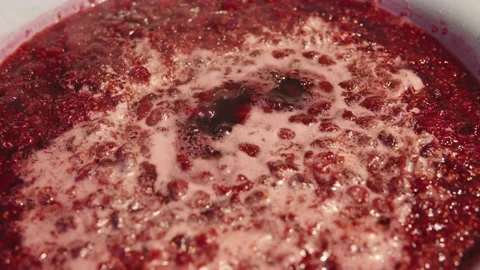 Process of making appetizing raspberry jam at home on the stove close-up. Stock Footage 210548361