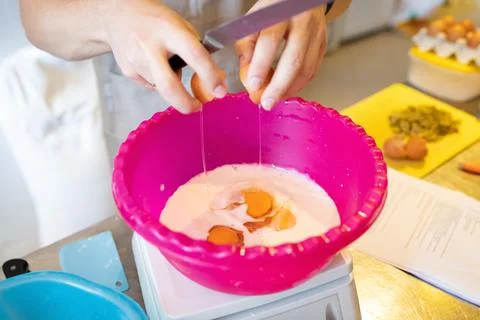 The process of making artisan bread. Adding eggs Stock Photos
