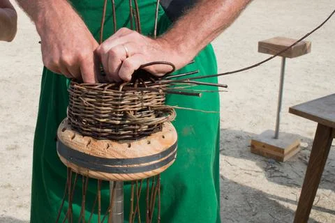 Process of making a basket. Man hands working on it. Stock Photos