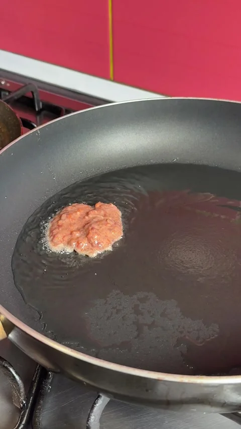 Process of making beef liver pancakes liver cutlets metal spatula flips a crispy Stock Footage 317697898