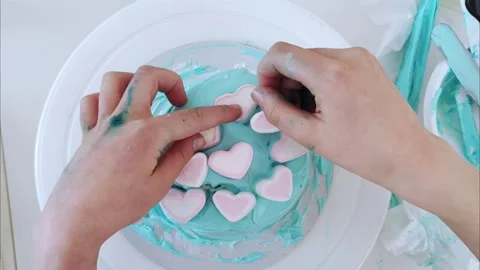 The process making bento cake children hand. Decorating cake with marshmallows Stock Footage 273556636