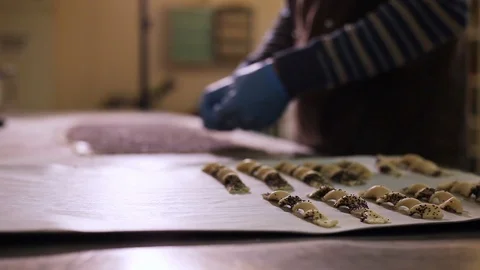 The process of making breadsticks with poppy seeds and sesame seeds in the baker Stock Footage 106484267