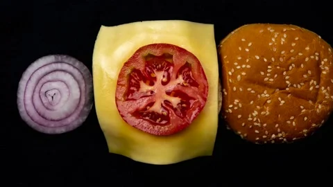 The process of making a burger from different ingredients. Stop motion animat Stock Footage 148423123