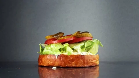 The process of making a burger from different ingredients. Stock Footage 159370490