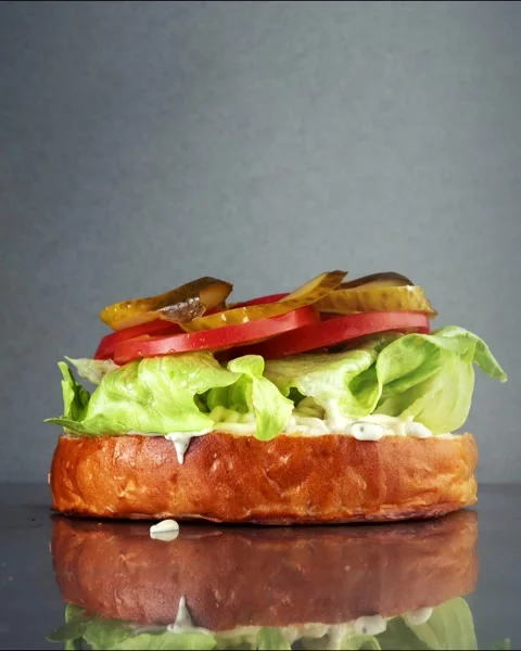 The process of making a burger from different ingredients. Stock Footage 168325537