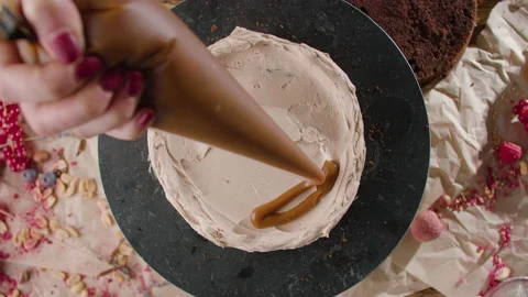 The process of making a cake. The pastry chef decorates the cake Stock Footage 168809754