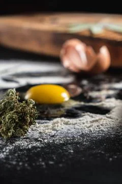 The process of making cannabis pastries. raw broken egg, a rolling pin, flour 스톡 사진