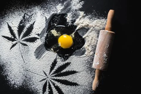 The process of making cannabis pastries. raw broken egg, a rolling pin, flour Stock Photos