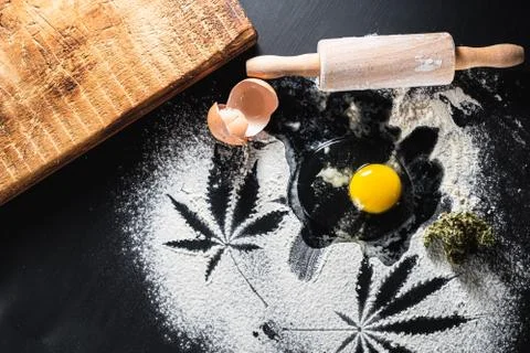 The process of making cannabis pastries. raw broken egg, a rolling pin, flour 스톡 사진